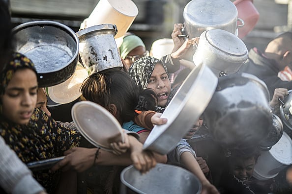 File photo : Palestinians in Rafah, Gaza, queue to receive food distributed by aid organizations (for representative purposes only) 