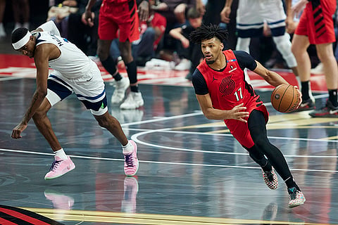 NBA Cup: Trail Blazers guard Shaedon Sharpe, right, dribbles past Timberwolves forward Jaden McDaniels 