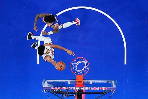 NBA: Cavaliers' Jarrett Allen, bottom, goes up for a shot against 76ers' Kelly Oubre Jr. 