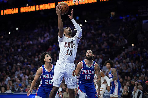 NBA: Cavaliers' Darius Garland (10) goes up for a shot against 76ers' Jared McCain (20) and Caleb Martin (16) 
