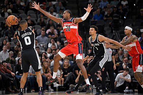 NBA: Spurs' Keldon Johnson (0) looks to pass as he is defended by Wizards' Alex Sarr (20) 