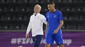 File : France coach Didier Deschamps (L) arrives for a team training session with Mbappe.