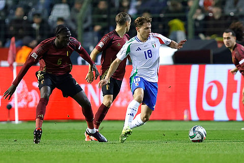 UEFA Nations League soccer: Italy's Nicolo Barella, center, fights for the ball with Belgium's Amadou Onana