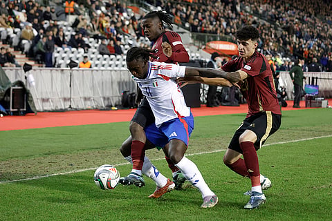 UEFA Nations League soccer: Italy's Moise Kean, center, fights for the ball with Belgium's Johan Bakayoko and Ameen Al-Dakhil 