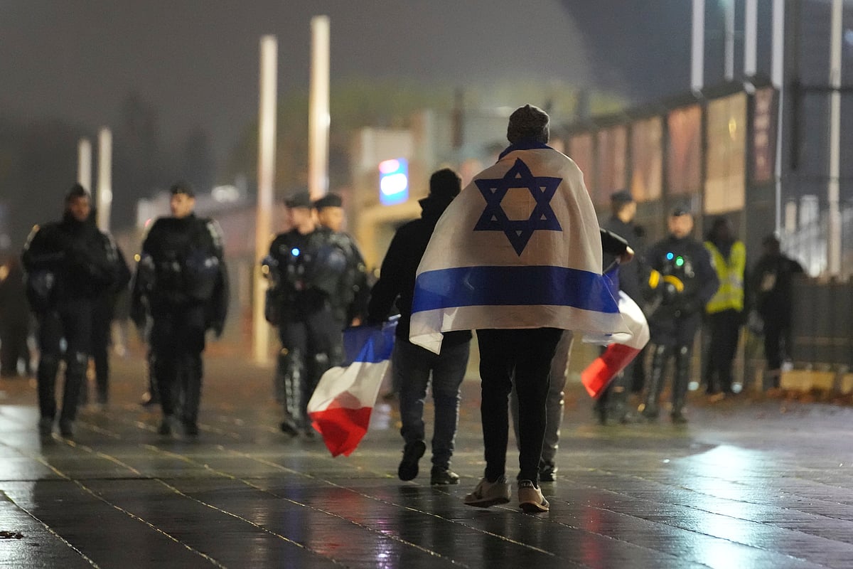 (AP Photo/Christophe Ena) : Soccer supporters leave after the Nations League soccer match France against Israel outside the Stade de France stadium, Thursday, Nov. 14, 2024 in Saint-Denis, outside Paris. 