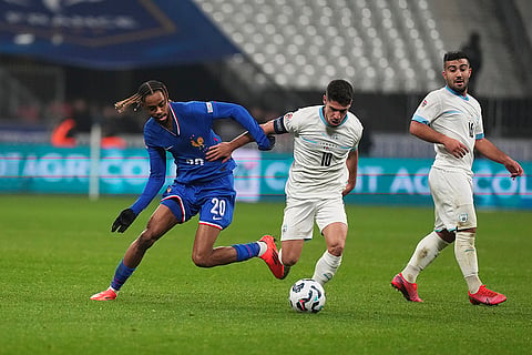 UEFA Nations League soccer: France's Bradley Barcola, left, challenges for the ball with Israel's Manor Solomon and Mohammad Abu Fani