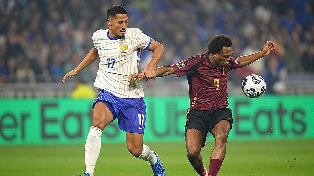 | Photo: AP/Laurent Cipriani : 2024–25 UEFA Nations League, France vs Belgium: France's William Saliba, left, tries to stop Belgium's Lois Openda