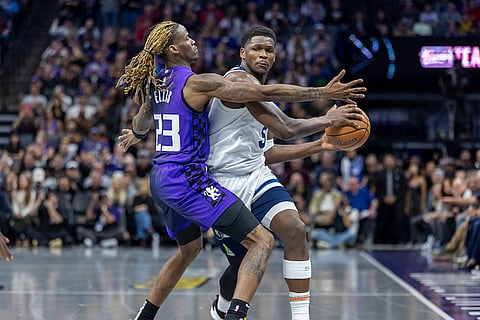 NBA: Timberwolves guard Anthony Edwards (5) dribbles the ball up court as  Kings guard Keon Ellis
