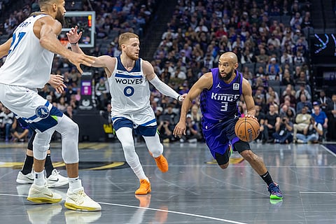 NBA: Kings guard Jordan McLaughlin (3) drives to the basket with Timberwolves guard Donte DiVincenzo (0) defending 