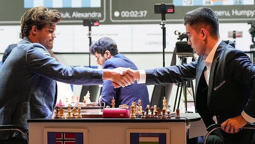 Tata Steel Chess India Rapid: Magnus Carlsen and Uzbek GM Nodirbek Abdusattarov exchange greeting  - | Photo: PTI/Swapan Mahapatra