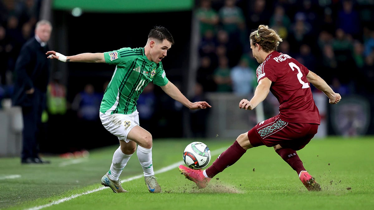 Liam McBurney/PA via AP : Northern Ireland's Paul Smyth, left, and Belarus' Kirill Pechenin in action during the UEFA Nations League soccer match at the National Football Stadium at Windsor Park, Belfast.