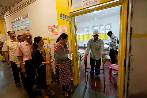 Maha Assembly polls: People wait in a queue to cast their votes in Mumbai