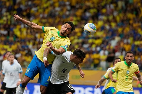 Football World Cup 2026 Qualifiers: Brazil's Marquinhos, left, and Uruguay's Mathias Olivera go for a header 