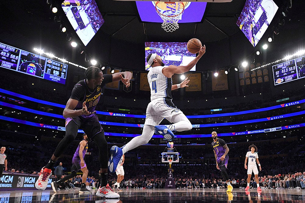 | Photo: AP/Mark J. Terrill : NBA: Magic guard Jalen Suggs, right, shoots as Lakers center Christian Koloko defends