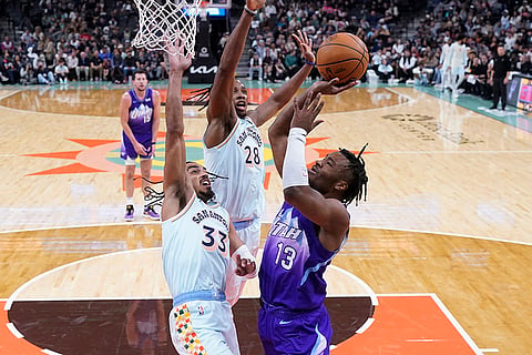 NBA: Jazz guard Isaiah Collier (13) drives to the basket against Spurs guard Tre Jones (33) 