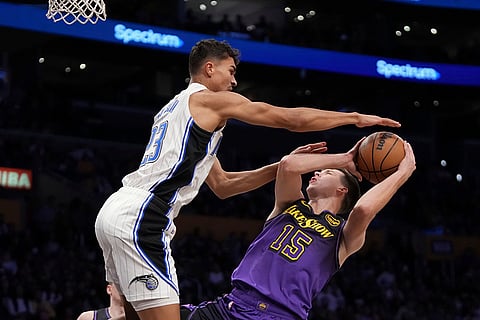 NBA: Lakers guard Austin Reaves, right, shoots as Magic forward Tristan da Silva defends