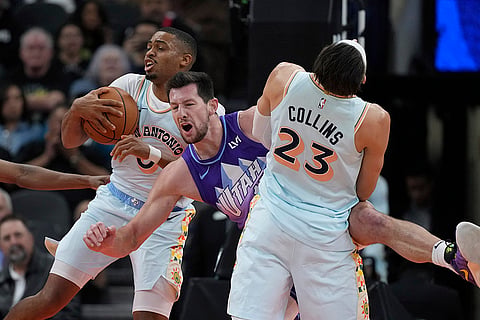 NBA: Jazz forward Drew Eubanks, center, battles Spurs forward Keldon Johnson (0) and forward Zach Collins (23) for a rebound