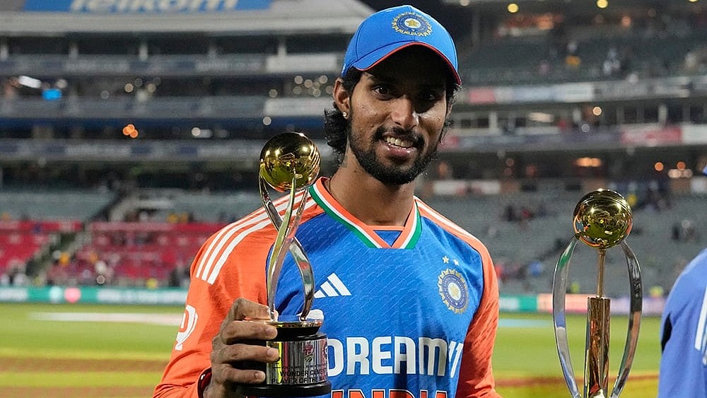 | Photo: AP/Themba Hadebe : India's Tilak Varma poses with the Player of the Match and Player of the Series trophies
