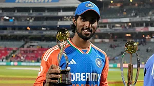 | Photo: AP/Themba Hadebe : India's Tilak Varma poses with the Player of the Match and Player of the Series trophies