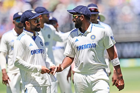 IND Vs AUS 1st Test, Day 2: India's captain Jasprit Bumrah, right, and teammate Virat Kohli as they leave the field 