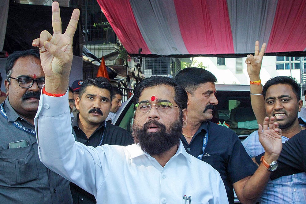 | Photo: PTI : Maharashtra Chief Minister Eknath Shinde flashes victory sign along with supporters |