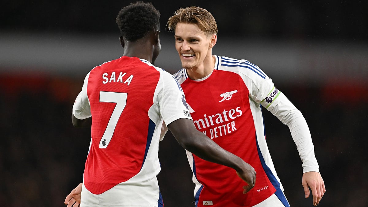 Martin Odegaard celebrates Arsenal's victory over Nottingham Forest with Bukayo Saka