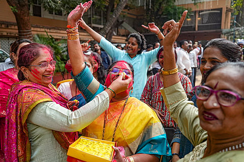 Supporters celebrate outside Eknath Shinde's residence