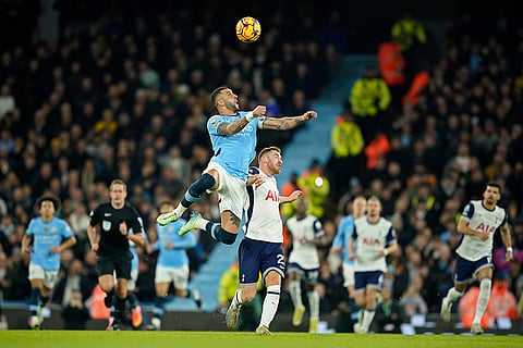 EPL 2024-25: Manchester City's Kyle Walker, centre left, jumps for the ball above Tottenham's Brennan Johnson