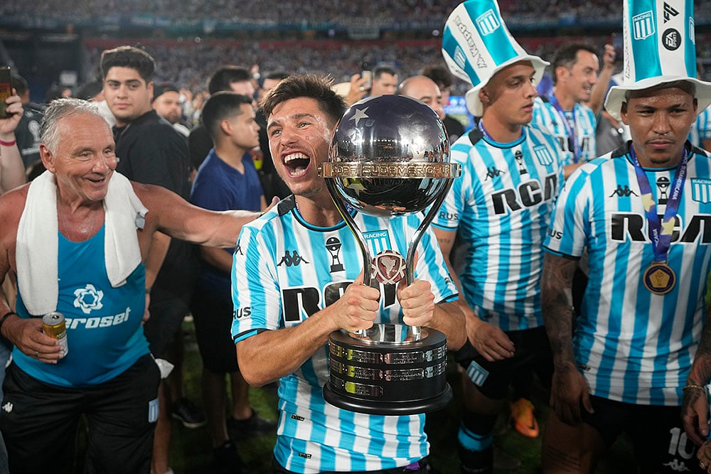 | Photo: AP/Jorge Saenz : Copa Sudamericana 2024 Final: Racing Club players celebrate with the trophy after winning the Copa Sudamericana final