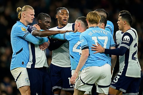 EPL 2024-25: Manchester City's Erling Haaland, left, holds back Tottenham's Yves Bissouma as he tussles with Manchester City's Phil Foden