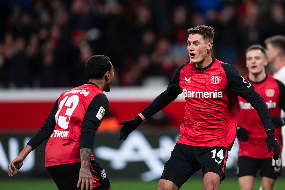 | Photo: Marius Becker/dpa via AP : Bundesliga 2024-25: Leverkusen's scorer Patrik Schick and his teammate celebrate their side's fourth goal