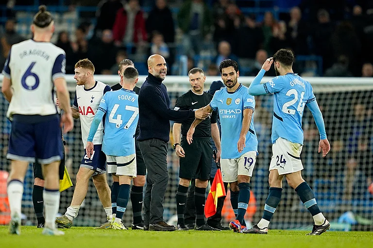 EPL 2024-25: Manchester City's head coach Pep Guardiola speaks with his players at the end of the match - | Photo: AP/Dave Thompson