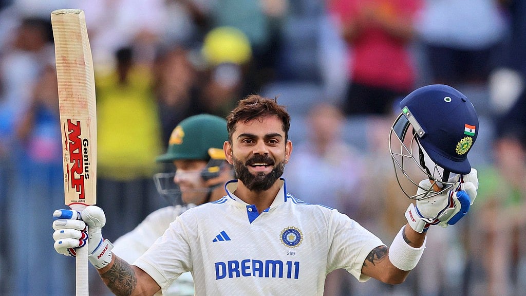 IND vs AUS 1st Test: Virat Kohli celebrates after reaching his century in Australia. - AP/Trevor Collens