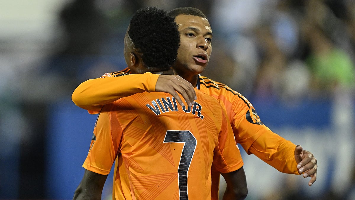 Kylian Mbappe celebrates with Vinicius Junior. - null