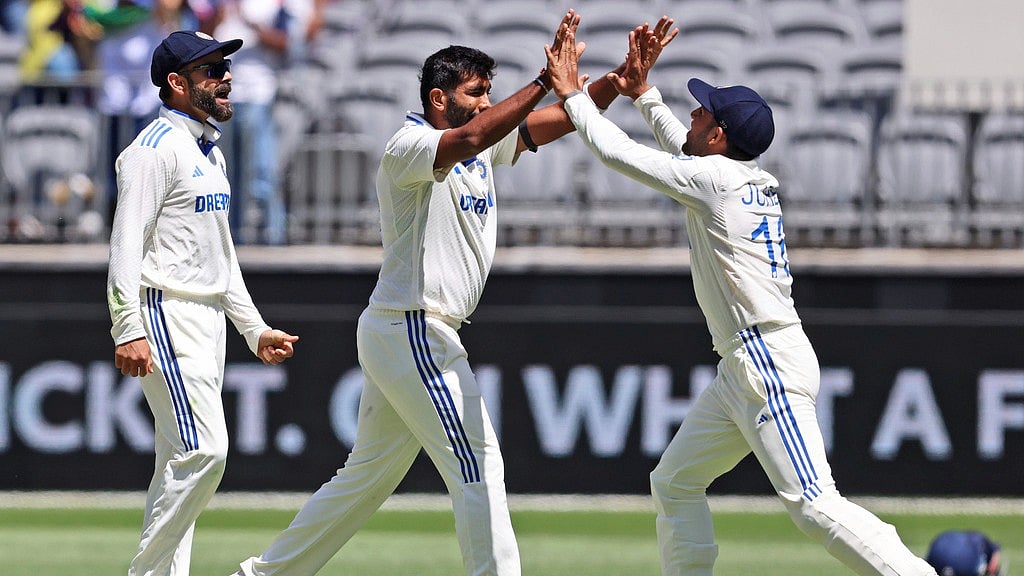 Jasprit Bumrah celebrates with teammate Dhruv Jurel the wicket of Travis Head during the first India vs Australia Test in Perth. - AP/Trevor Collens