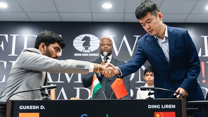 X/FIDE : Ding Liren and D Gukesh shake hands after the first round of World Chess Championship.