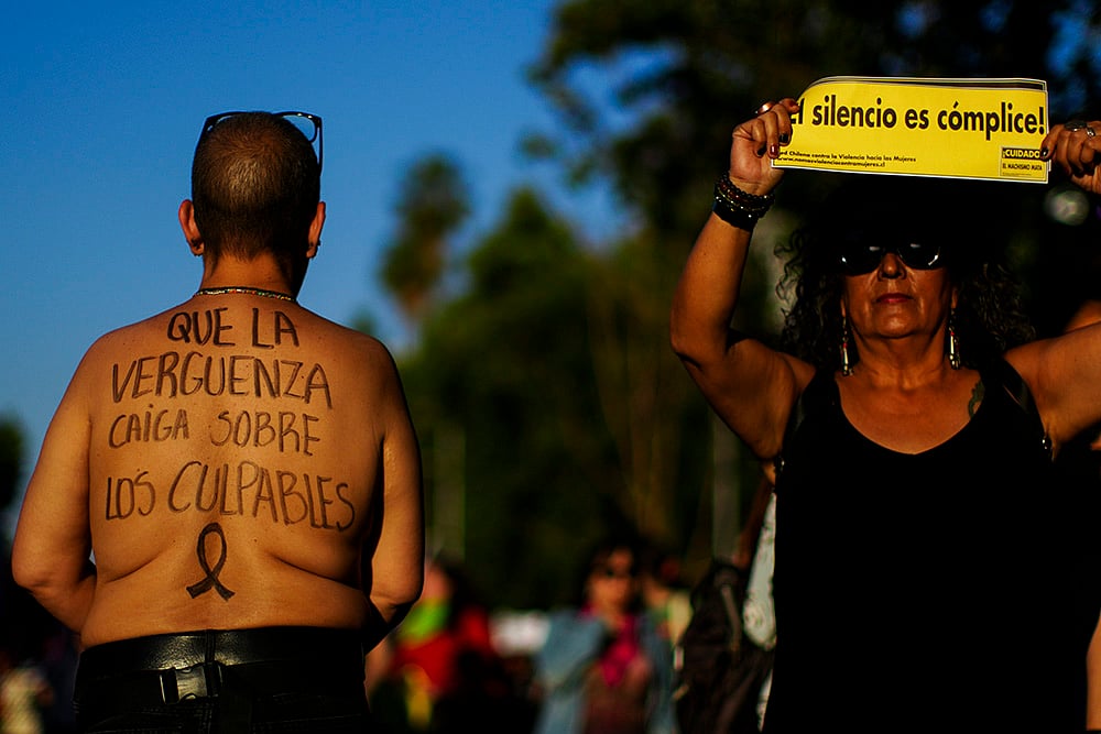 | Photo: AP/Esteban Felix : People perform during a march in Santiago, Chile