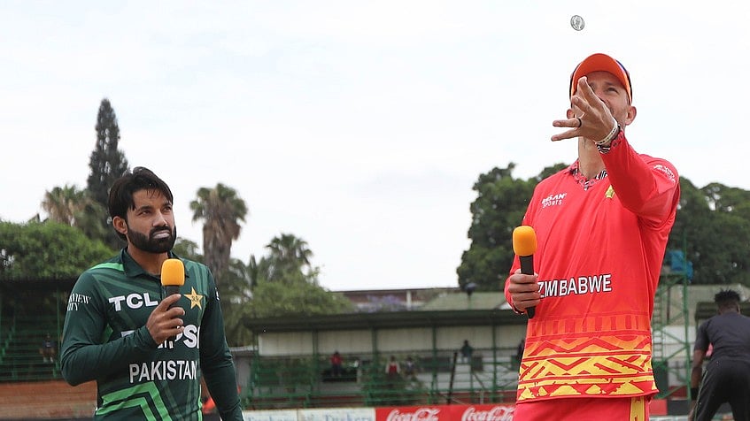 AP : Pakistan's cricket captain Mohammad Rizwan looks on as Zimbabwe's Captain Craig Ervine tosses the coin.