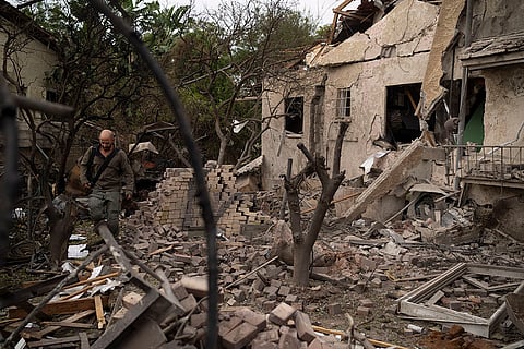 Middle East Tensions: Israeli security personnel examine a Rinatya impact site