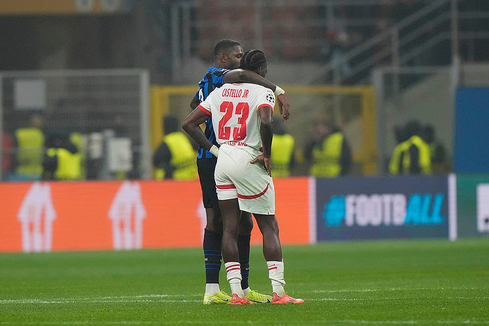 | Photo: AP/Luca Bruno : UEFA Champions League: Inter Milan's Marcus Thuram, left, hugs Leipzig's Castello Lukeba 