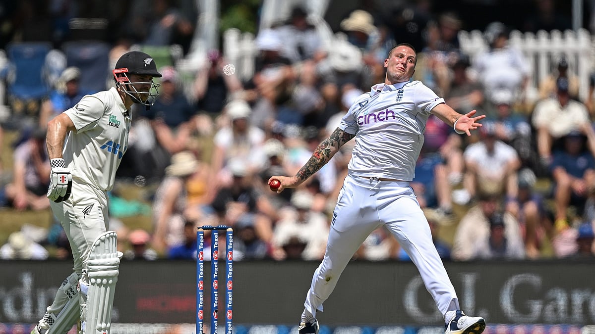 Englands Brydon Carse, right, bowls as Williamson watches. AP Photo