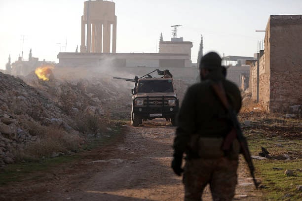 Getty Images : Fighters fire towards Syrian Army troops in the Rashidin district on the outskirts of Aleppo on November 29, 2024
