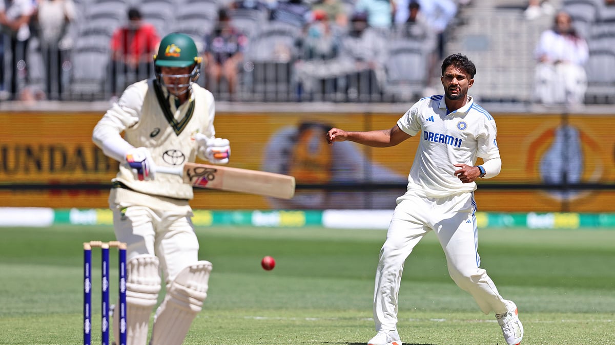 Indias Nitish Kumar Reddy, right, throws the ball at the stumps. AP Photo