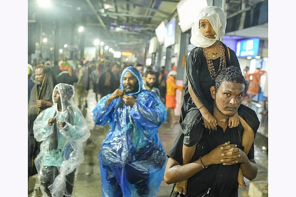 | Photo: PTI : Devotees at Sabarimala temple