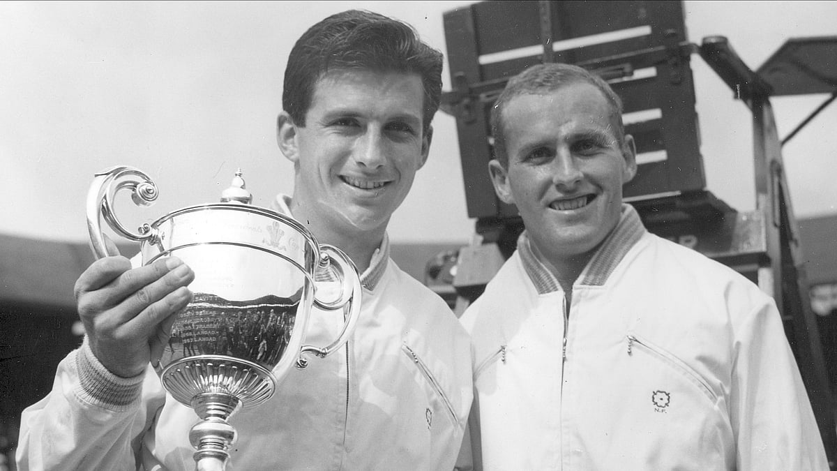 AP Photo, File : Ashley Cooper left, holds the winner's trophy and poses with Neale Fraser after winning the men's singles championship in Wimbledon.