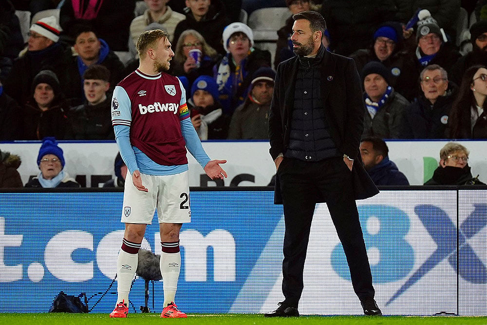 English Premier League: Ruud van Nistelrooy, right, waits with West Ham United's Jarrod Bowen on a VAR check - | Photo: Mike Egerton/PA via AP