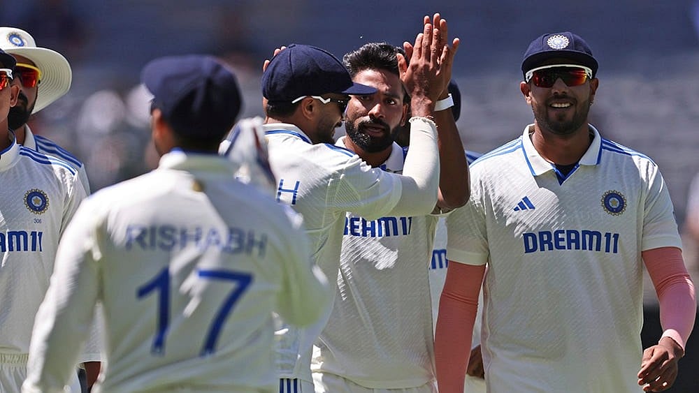 | Photo: AP/Trevor Collens : IND Vs AUS 1st Test, Day 4: India's Mohammed Siraj, center celebrates with teammates the wicket of Australia's Usman Khawaja
