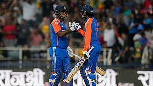 | Photo: AP/Themba Hadebe : IND vs SA 4th T20: India's Sanju Samson, left, celebrates with batting partner Tilak Varma after scoring a century