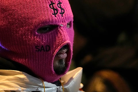 Pro-EU protests in Georgia: A demonstrator wearing a mask attends a rally