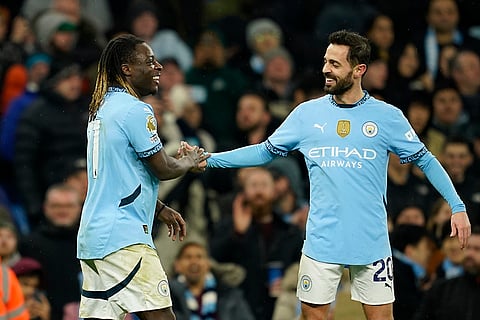 EPL 2024-25: City's Jeremy Doku, left, celebrates after scoring his side's third goal with Bernardo Silva